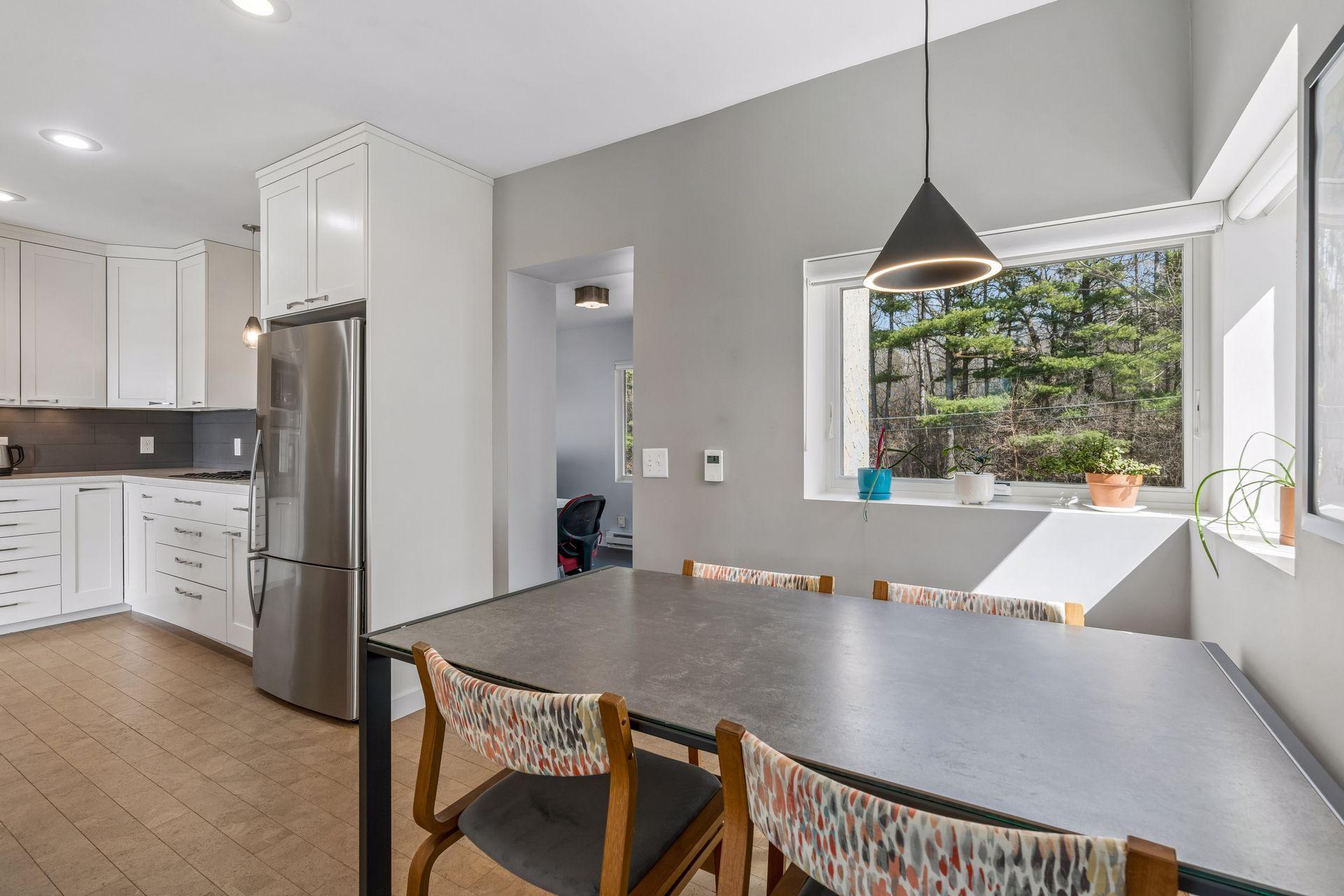 A small expansion was added to align the kitchen wall and create a dining nook. With the expansion in 2019, 2 Marvin awning windows with custom blinds and a relocated to side door were installed.