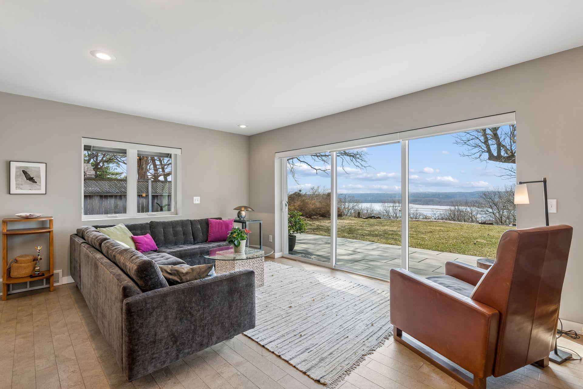 Bright and airy west facing living room takes full advantage of the wall of glass.