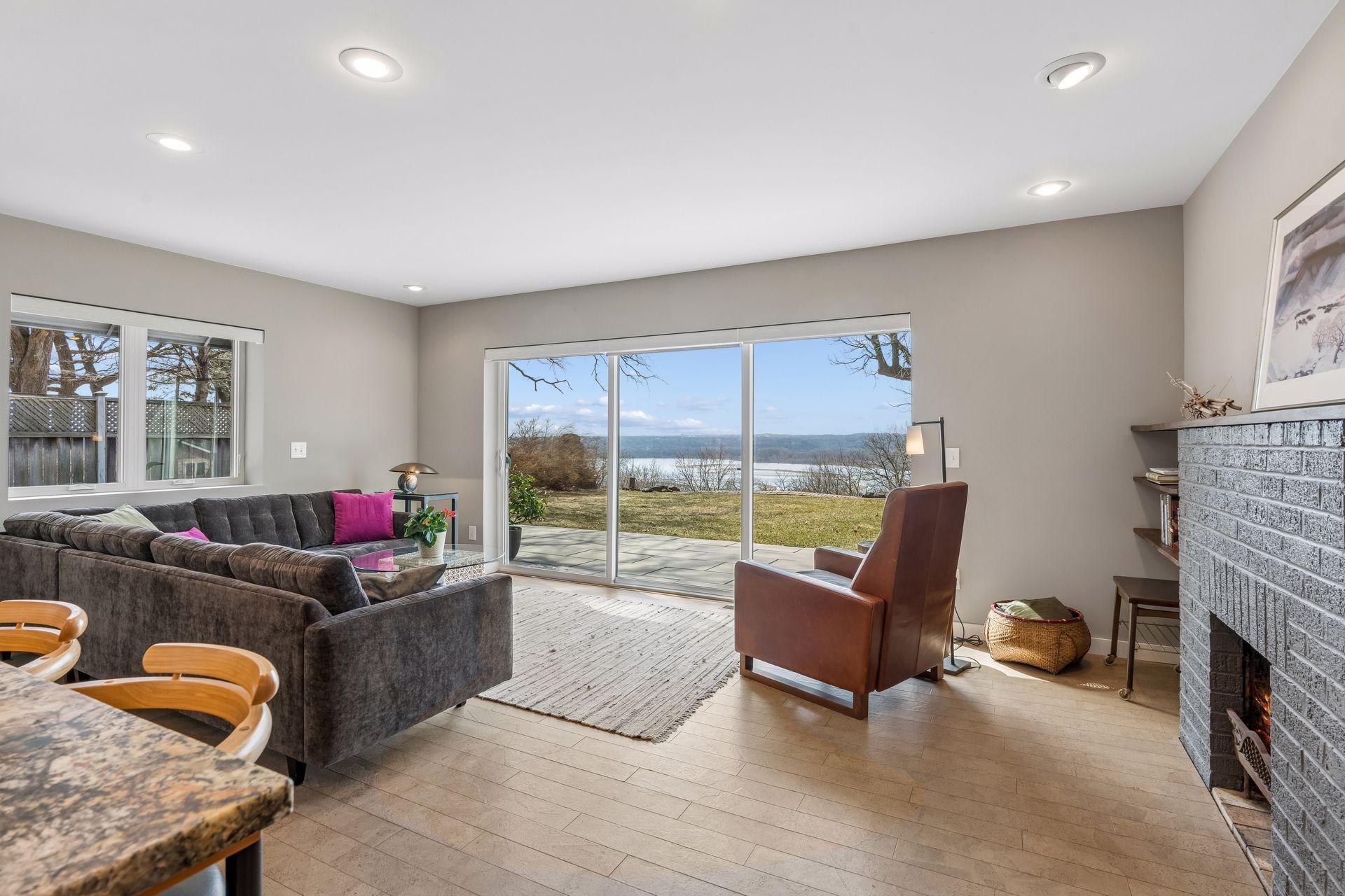 The living room also features concrete floors with cork flooring, brick wood burning fireplace and recessed lighting.