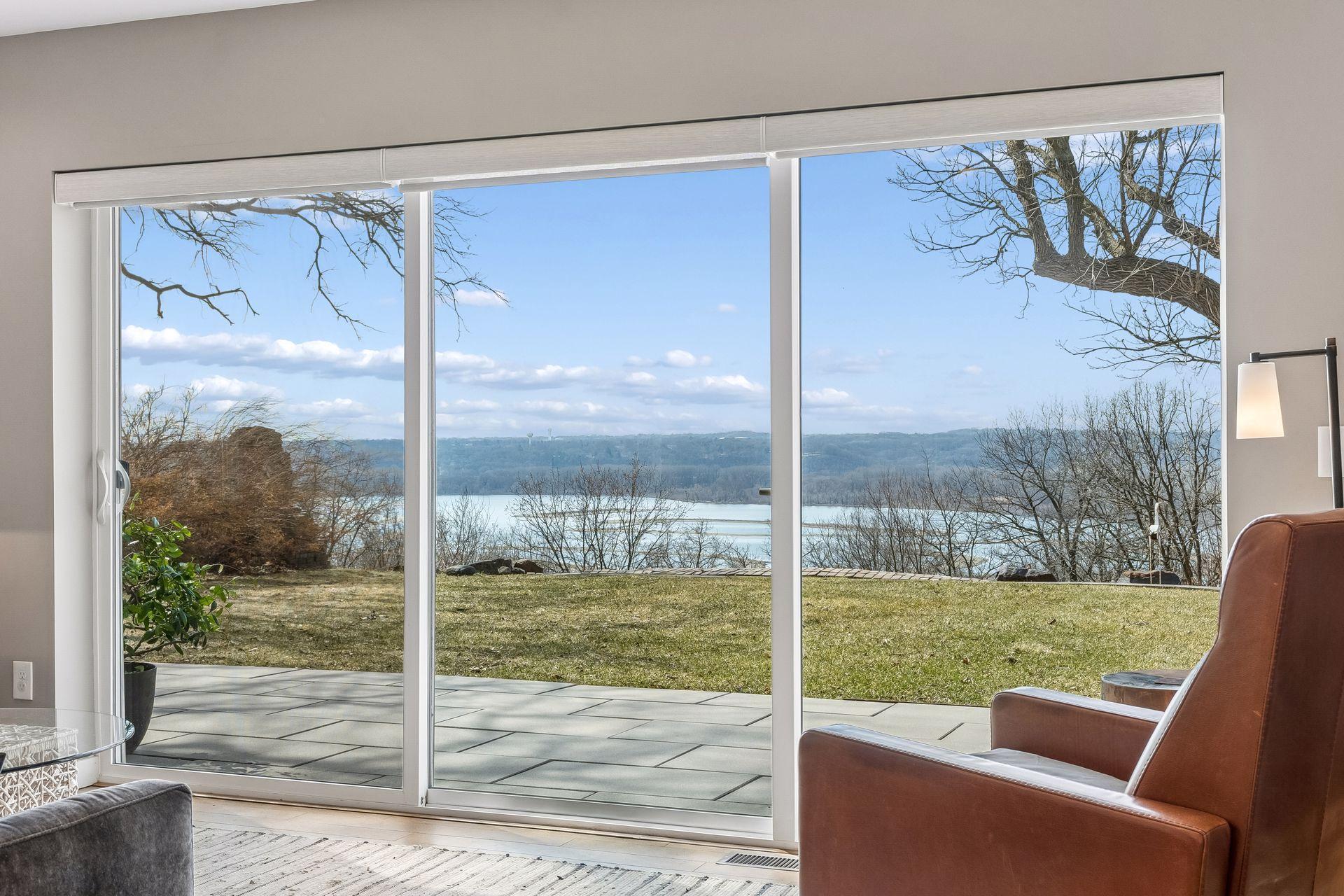 Absolute perfection! Stunning views of Pigs Eye Lake through a multi-panel sliding glass door with fixed panel offers big impact and panoramic scenic views year round. Installed 2010.
