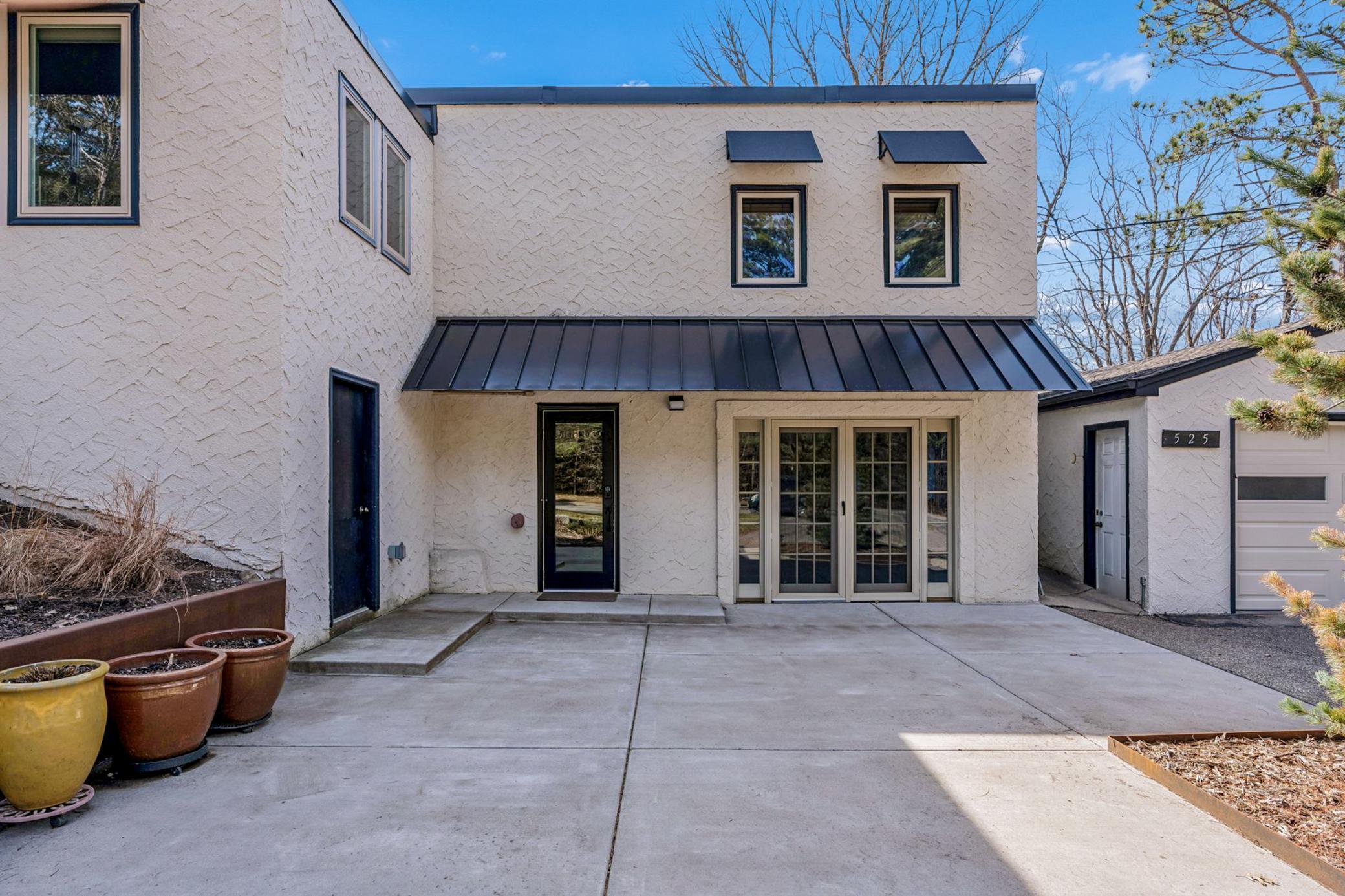 Main entrance, French doors to lower family room, and to left is a large storage/gardeners room.