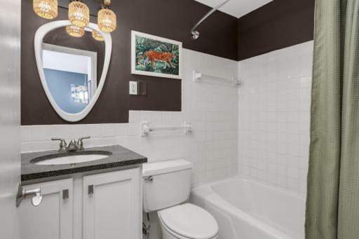 Chic bath with linen closet in hallway for add'l storage.