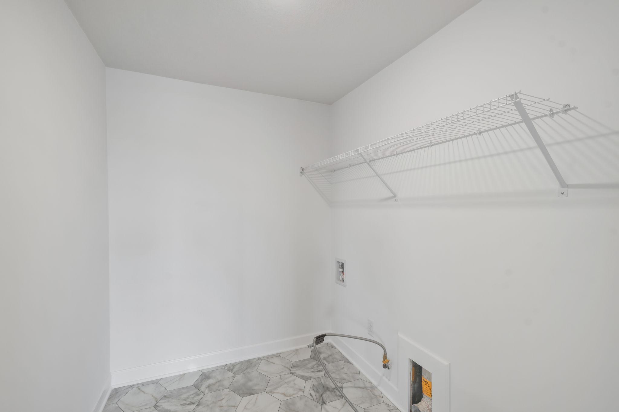 Laundry room with ventilated shelving for your convenience