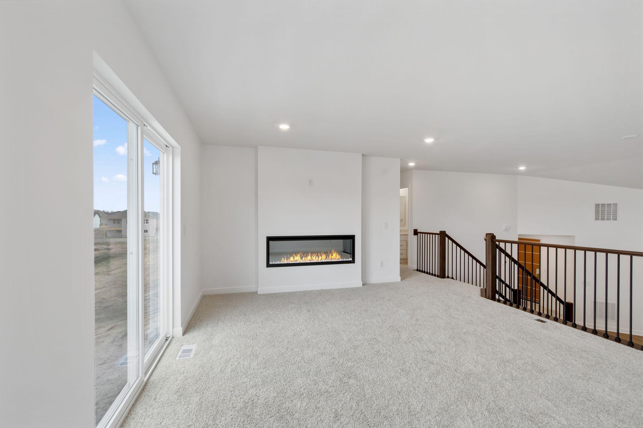 The inviting Great Room offers the space and comfort needed for seamless entertaining, with sliding glass doors offering convenient outdoor access.