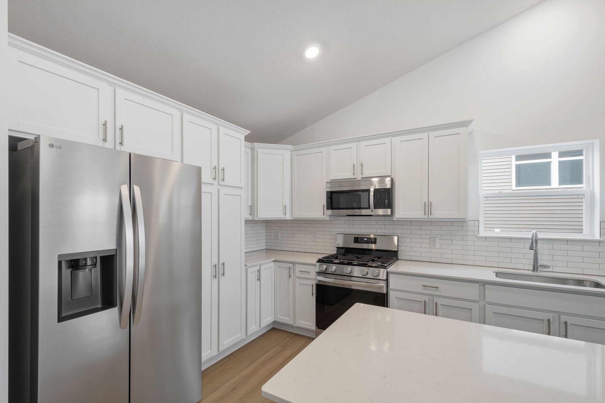 Spacious quartz countertops and brand-new stainless steel appliances will elevate culinary endeavors