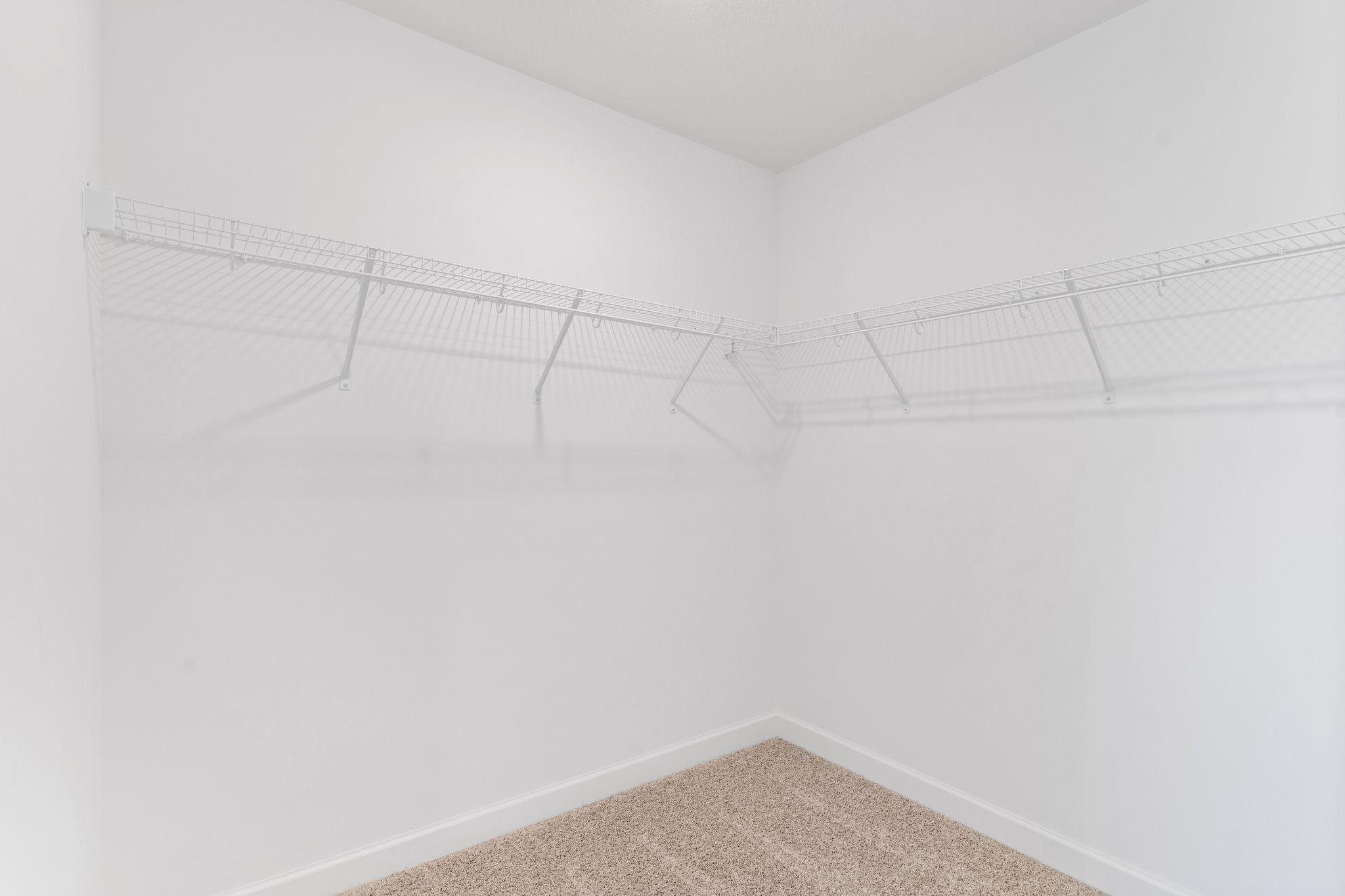 Fit for expansive wardrobes, this oversized walk-in closet comes with mesh-wire shelving to optimize organization and maximize storage space