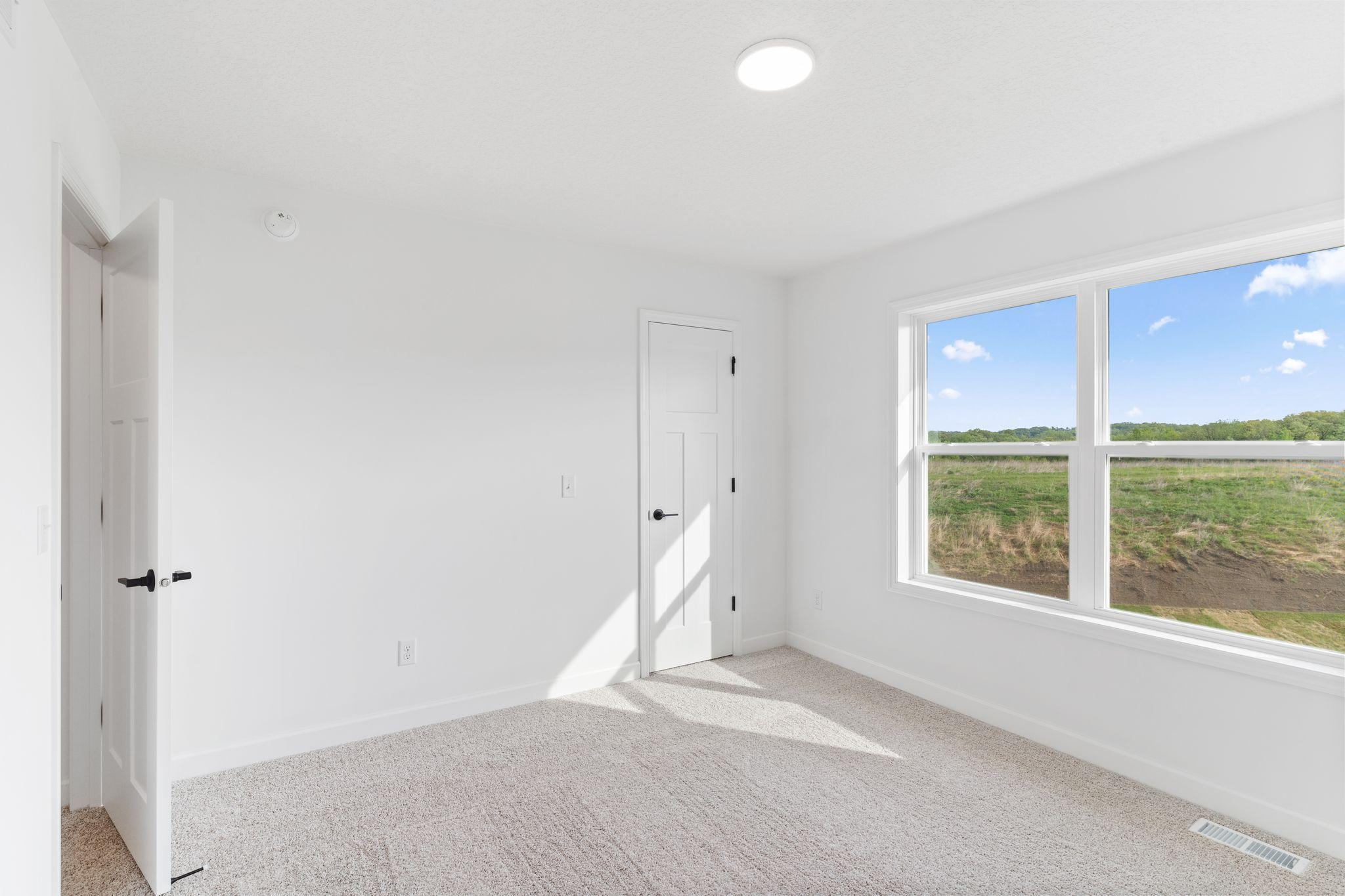Three secondary bedrooms can be found upstairs, just down the hall from the owner’s suite.