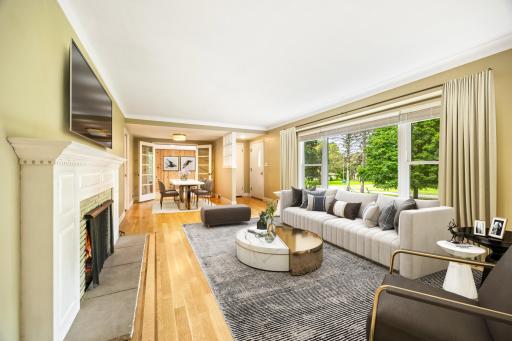 12 Virtually Staged Living Room toward Sunroom.jpg