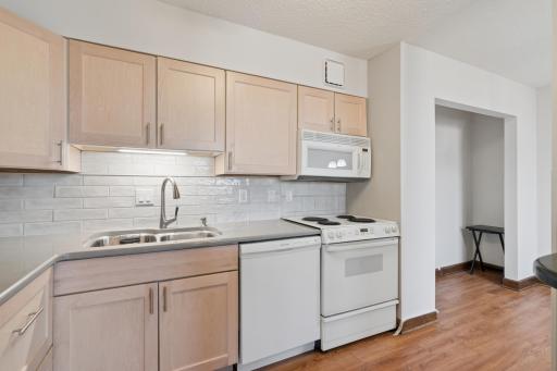 Quartz countertops, under mount sink and tile back splash.