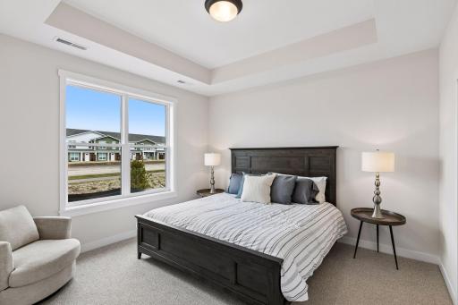 Primary bedroom highlighted by beautiful tray ceiling