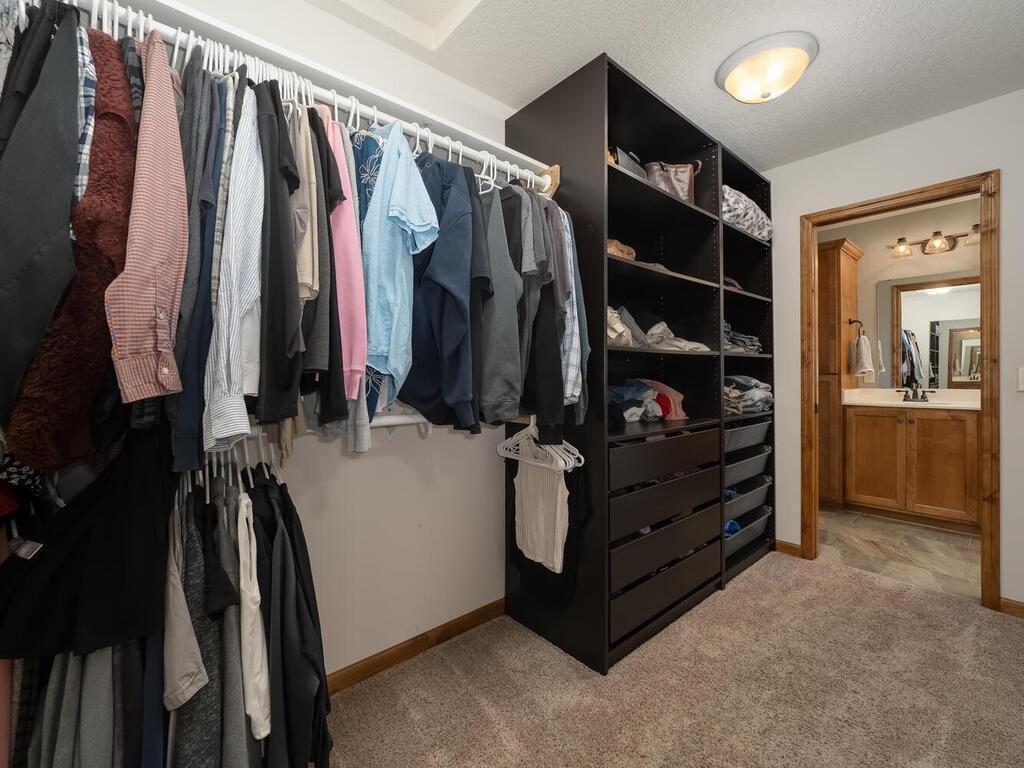 Walk-in primary closet that also connects to laundry room