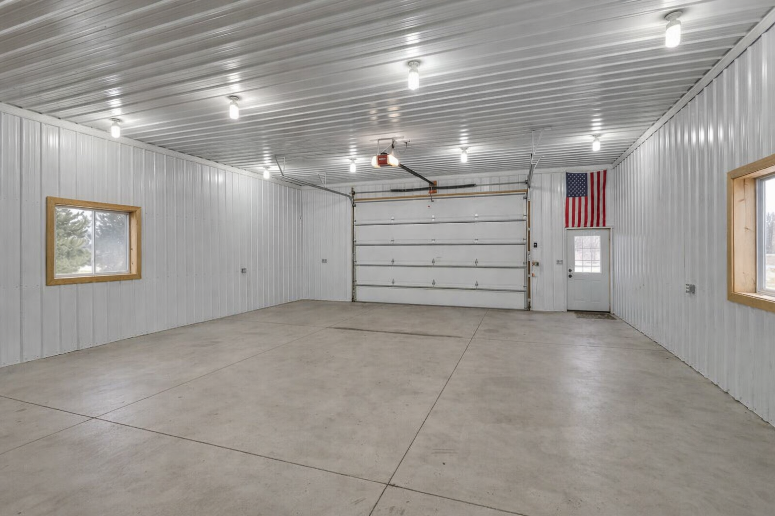 30x60 heated out building - has base and upper cabinets on back half. 12' walls