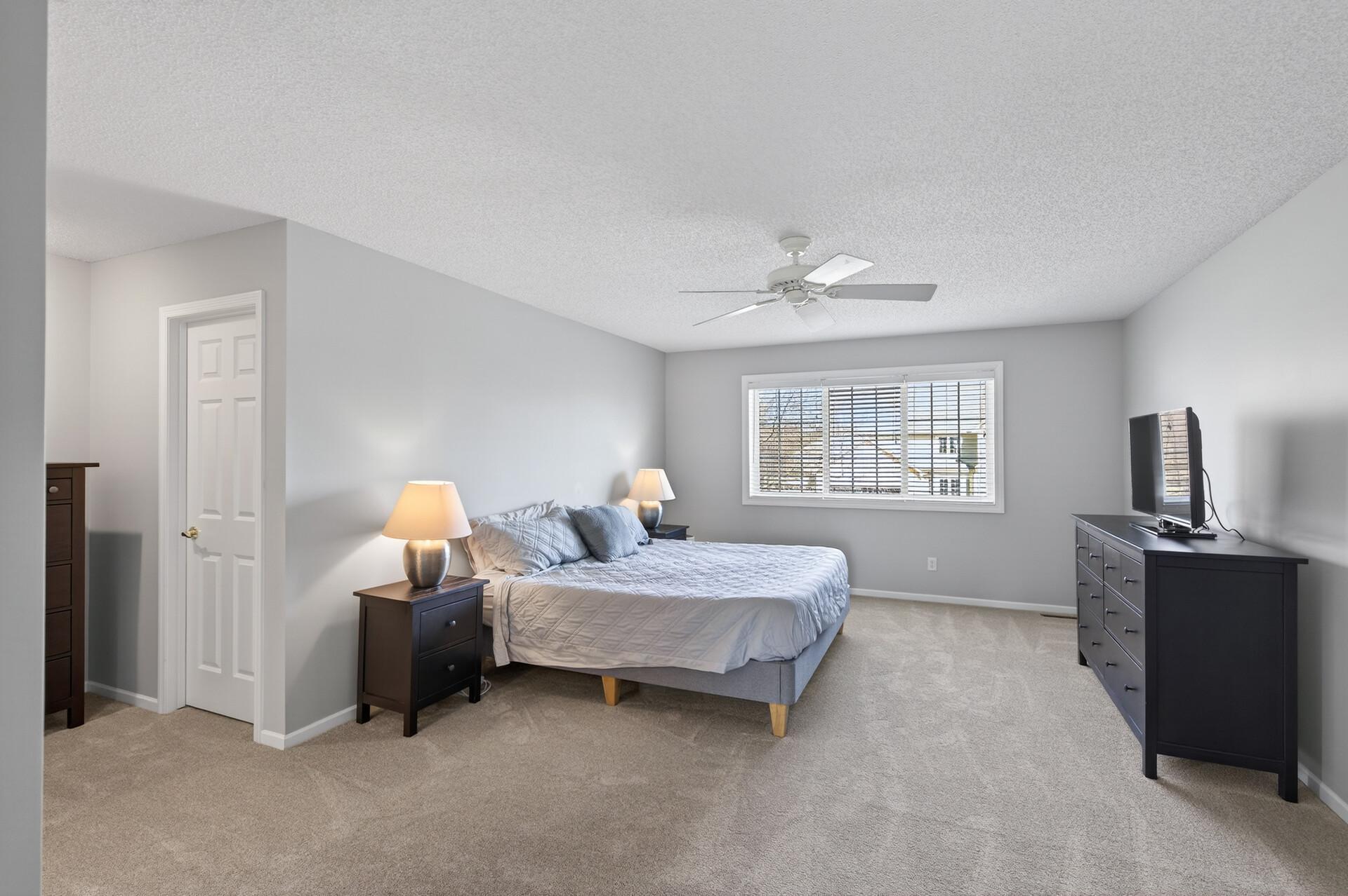 Primary suite with a walk in closet.