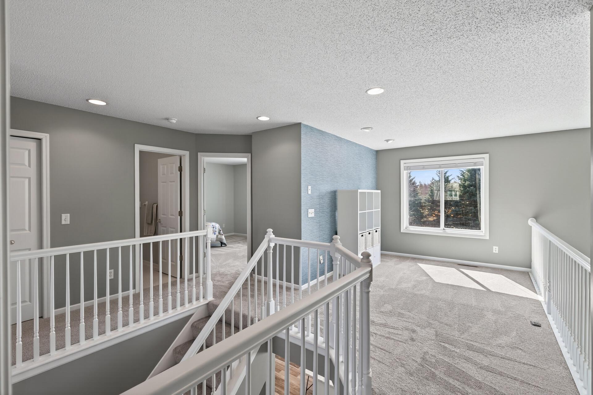 Spacious loft overlooking the main level adds light, openness, and versatility.