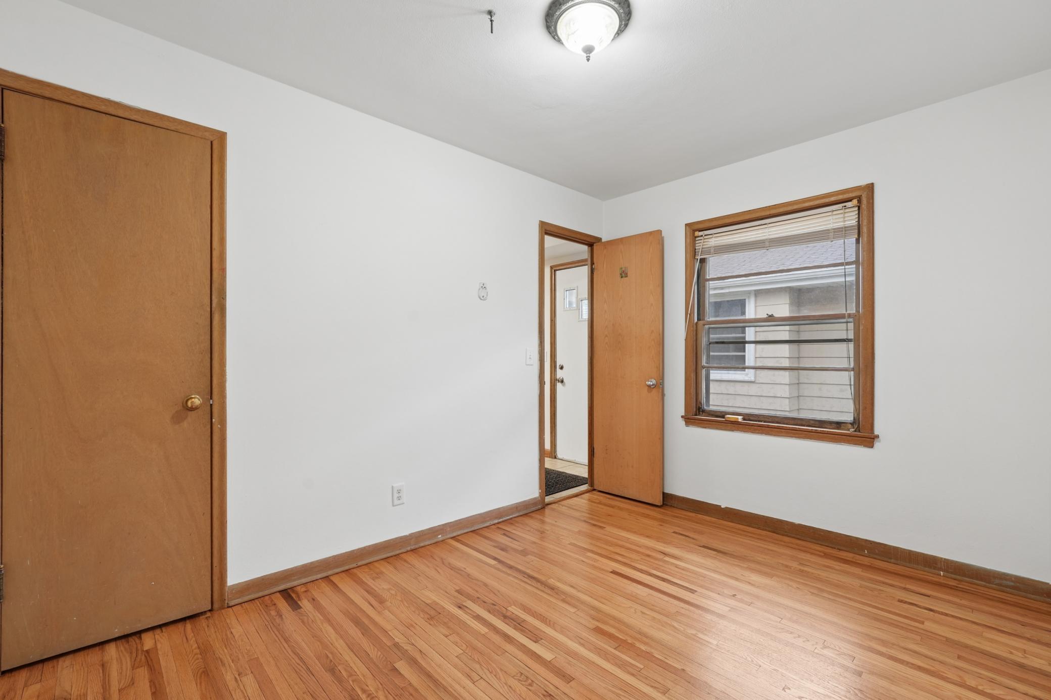 This bedroom leads you back to the kitchen and side entry.