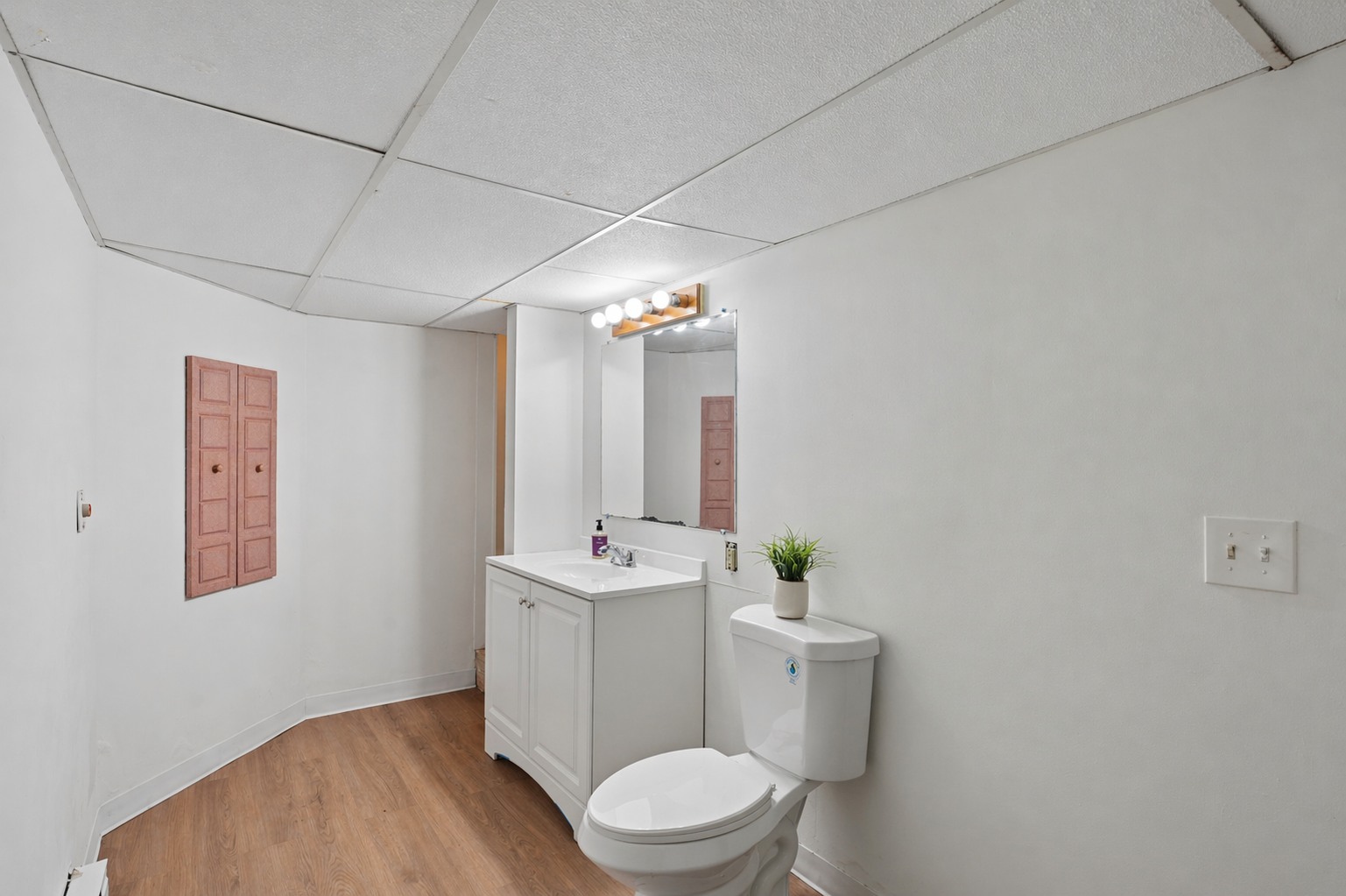 Refreshed lower level three-fourth bath with a new vanity, toilet and flooring