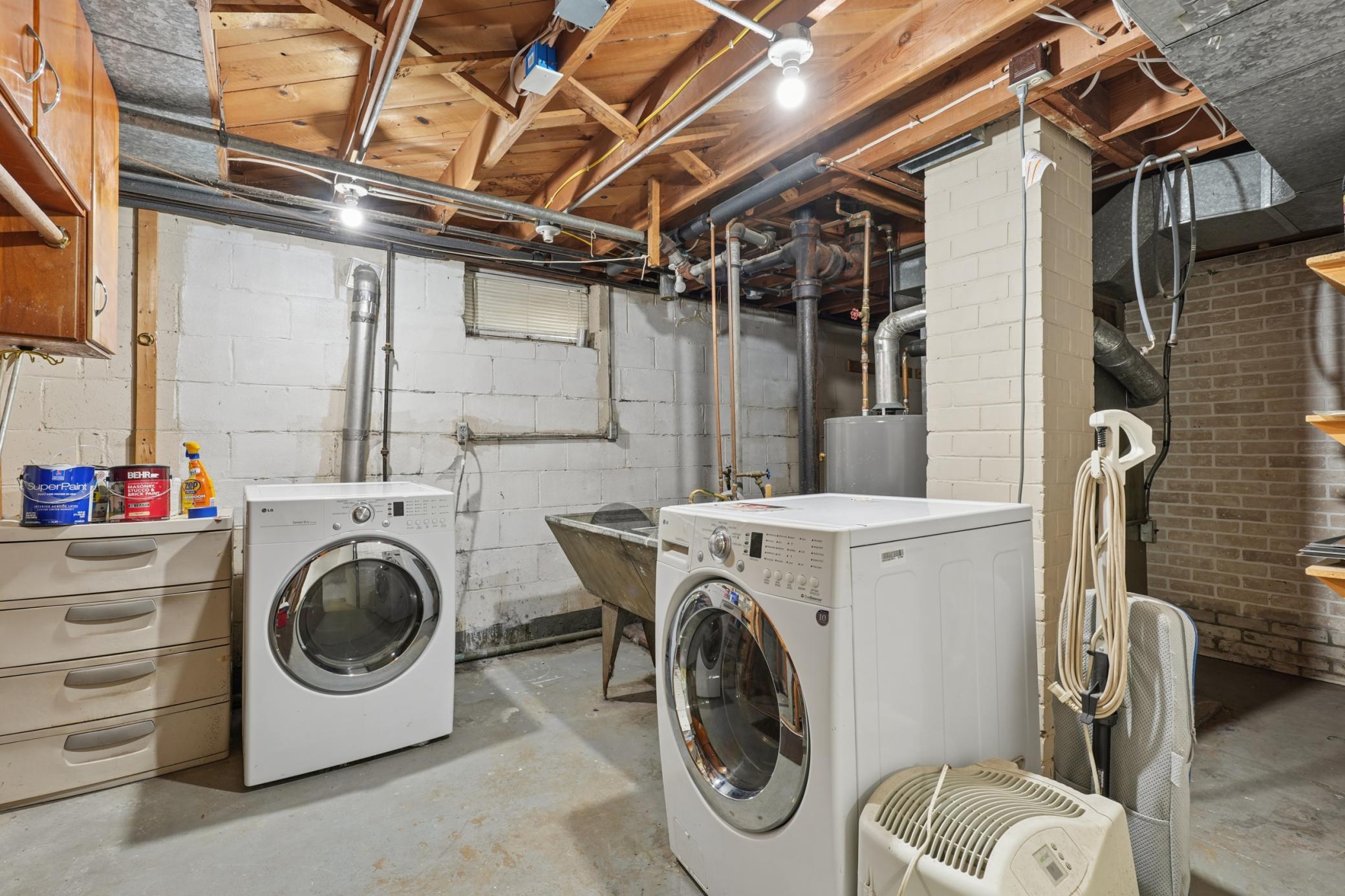 Functional laundry and utility area featuring a workshop space and upgraded electrical