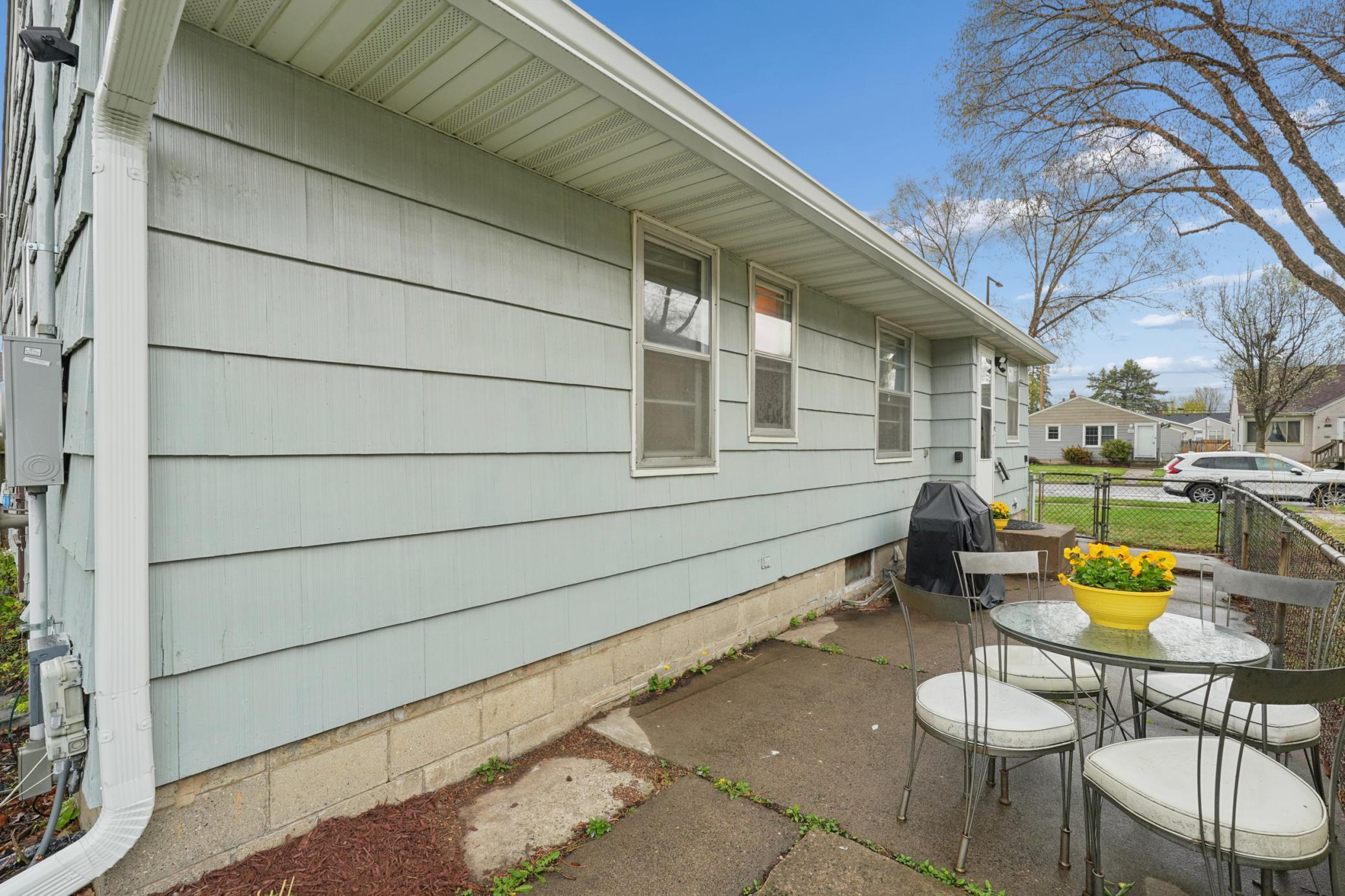A lovely patio area featuring a gas grill and seating