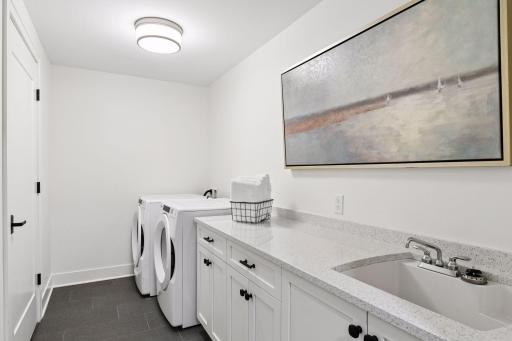 Laundry in the unit with a sink and great cabinet/counter space