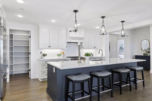 Kitchen features include high-end SS appliances, oversized center island, and cambria countertops