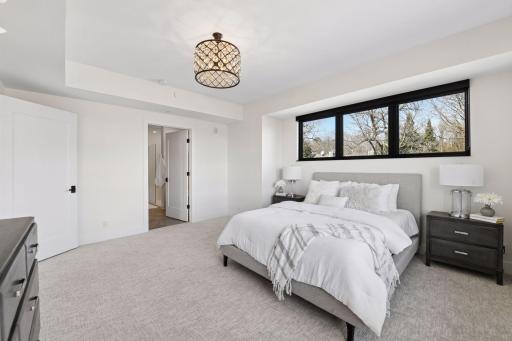 Primary bedroom has an en-suite full bathroom floods with natural light