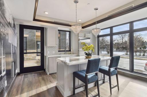The clubroom kitchen space offers access to the shared patio with a fireplace