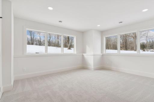 Lower level 5th bedroom with two walls of windows.