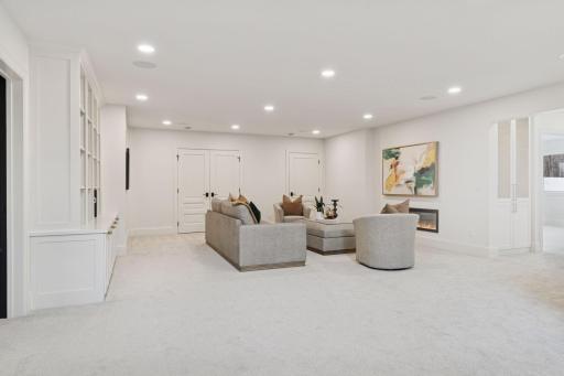 Spacious lower level with built-ins, shelving, and plentiful storage.