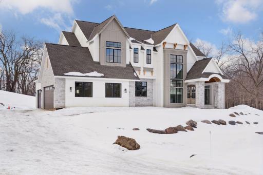 The steep gables and architectural trim add character, while the arched entryway provides a warm, inviting touch.