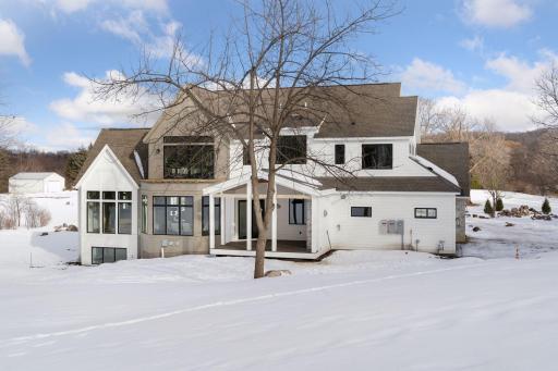 Vaulted three-season porch overlooking rolling acreage, capturing sweeping views and filling the space with natural light.