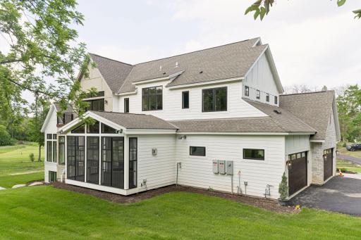 Vaulted three-season porch overlooking rolling acreage, capturing sweeping views and filling the space with natural light.