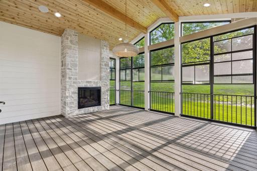 Three season porch with Easy Screens, Trex composite decking, and custom steel railing.