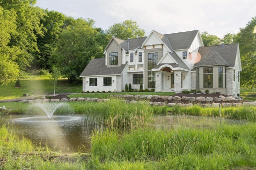 The steep gables and architectural trim add character, while the arched entryway provides a warm, inviting touch.
