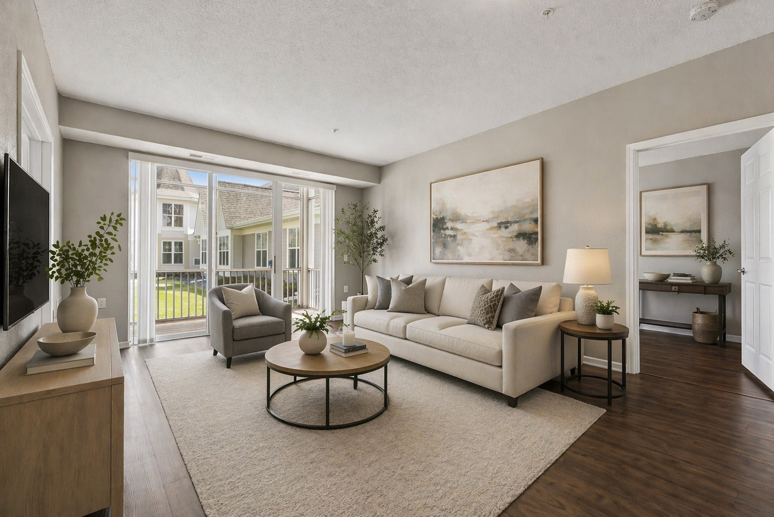 Virtually staged living room with 9-foot ceilings, an open floor plan, wood-look LVT flooring, and large sliding glass doors that flood the space with natural light.