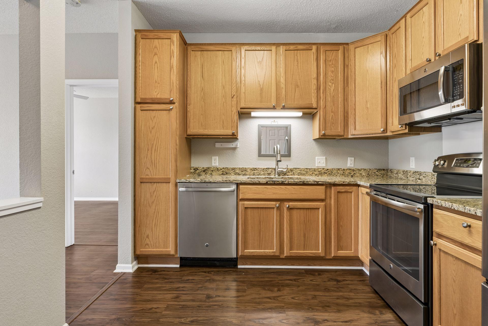 Stainless steel double sink and faucet with under cabinet light over the sink.