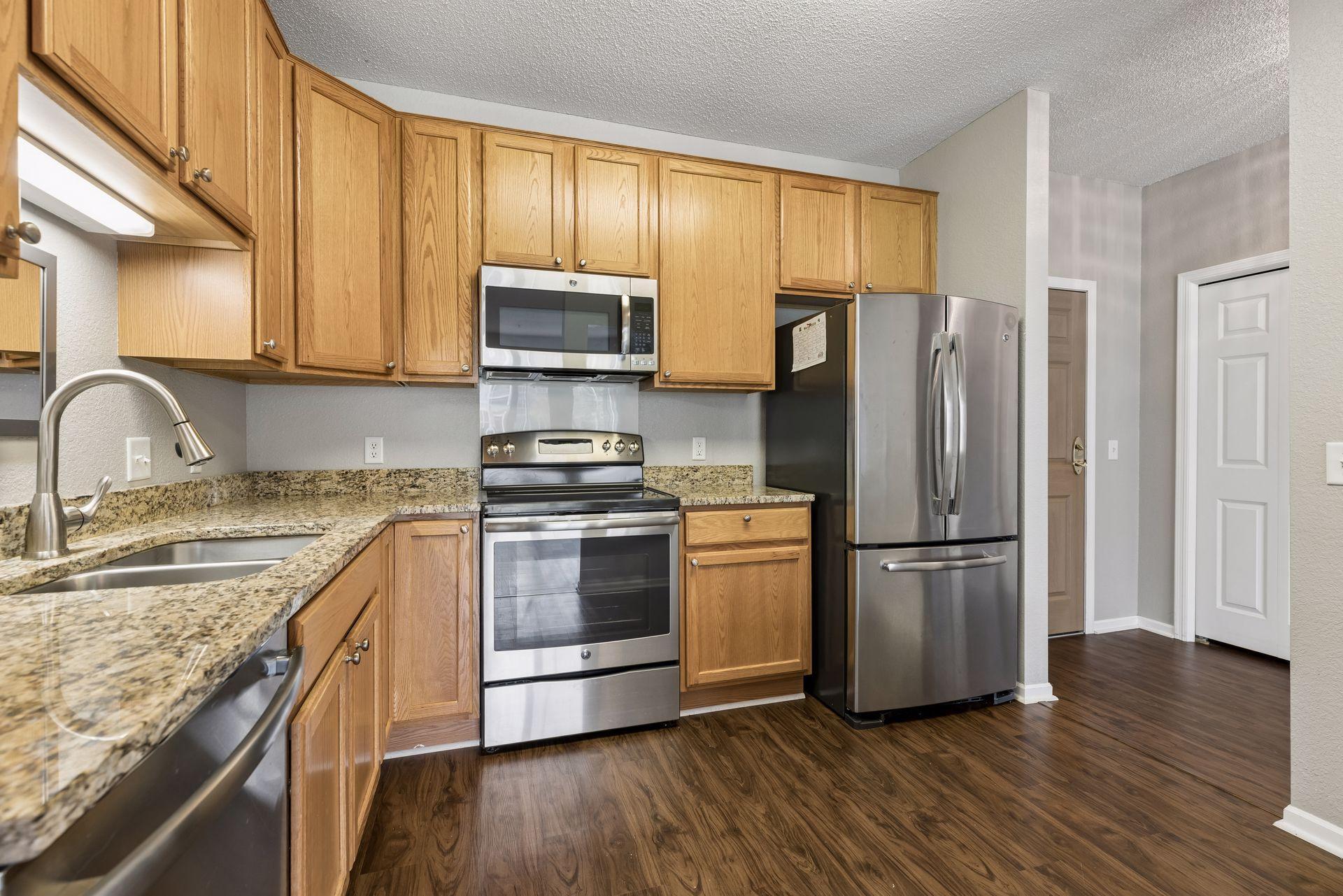 Beautifully updated kitchen featuring granite countertops, stainless steel appliances, and ample cabinetry.