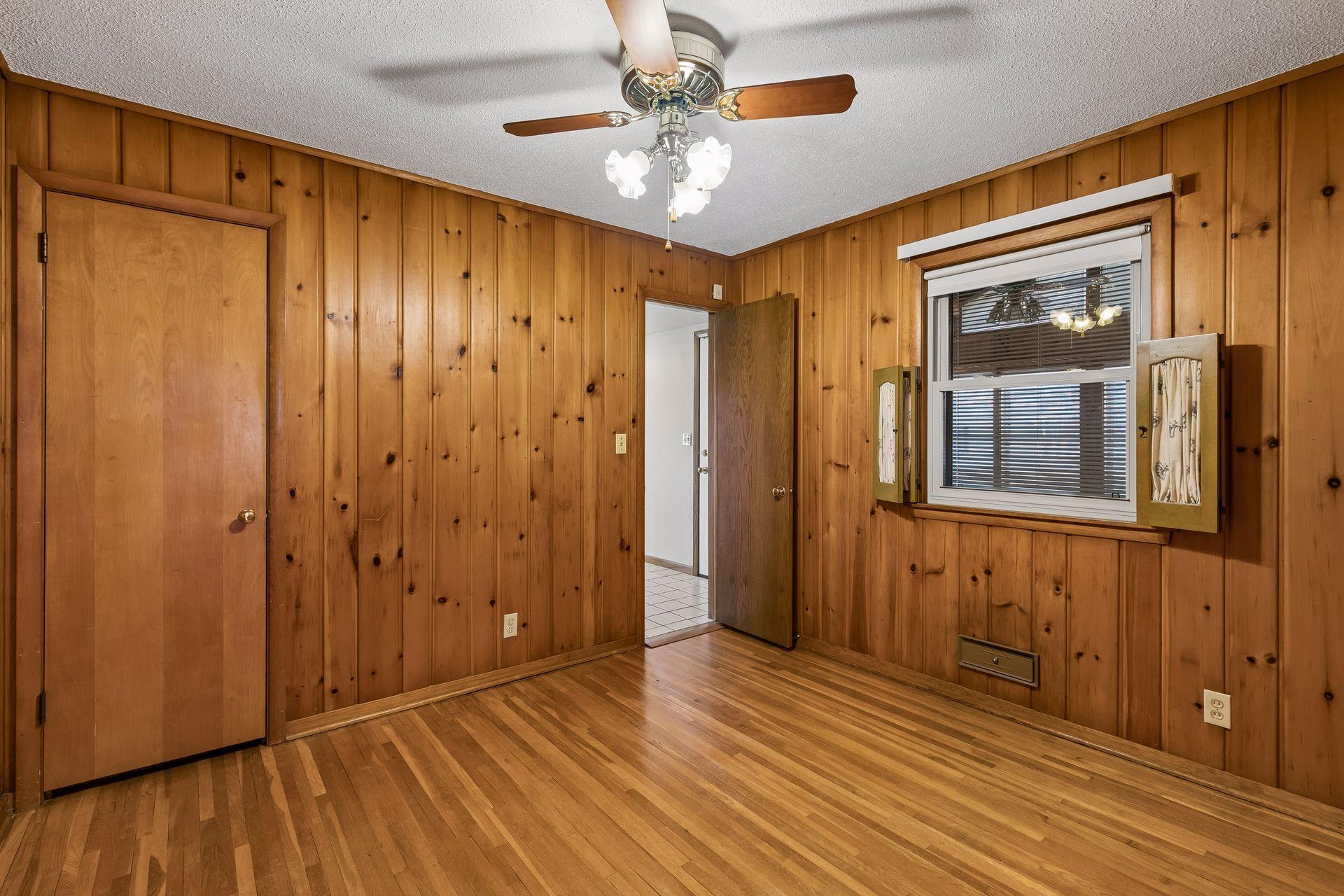Alternate view of the space, highlighting its generous closet and convenient access to the kitchen.