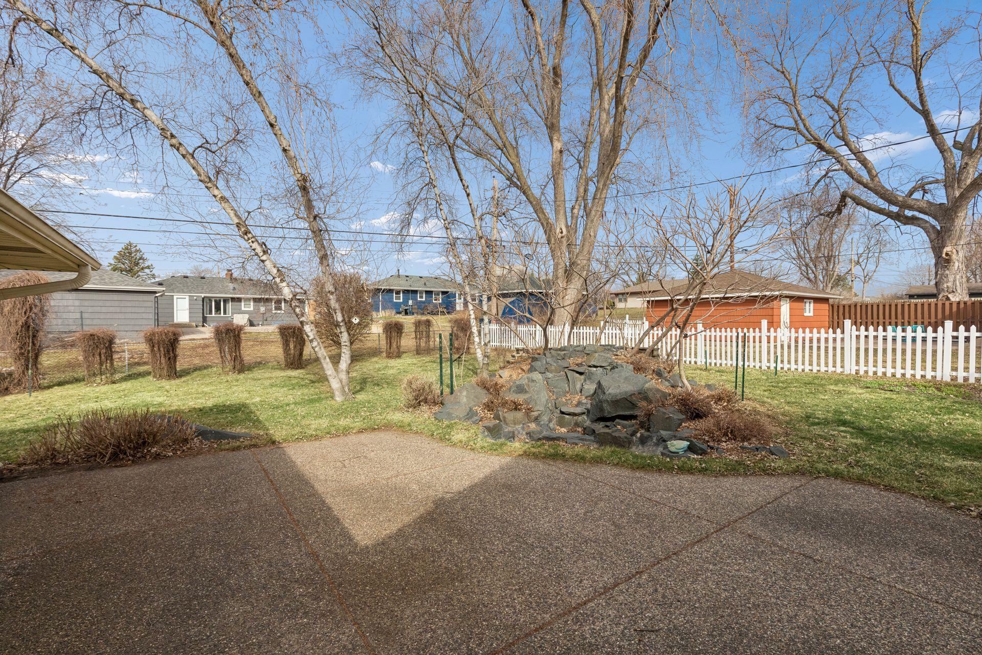 Charming landscaped yard with mature greenery- offering potential for customization.