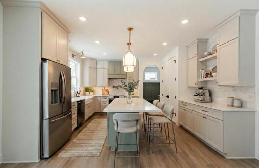 Stunning gourmet kitchen with stainless steel appliance and extended kitchen island with quartz countertops! *Photos are from a prior model-Majority of shown options are included in the sales price. Virtually staged to show design options.