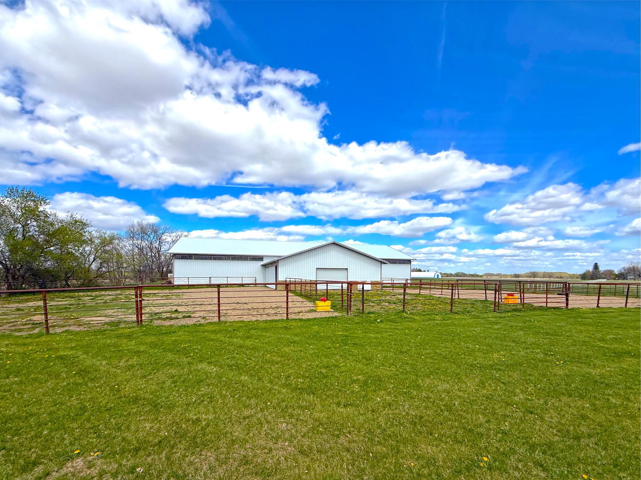 Equestrian enthusiasts will appreciate the well-equipped barn and outbuildings designed with both functionality and convenience in mind.