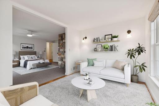 Luxurious master bedroom retreat featuring large windows, and a serene color palette. Complemented by a cozy sitting area, perfect for relaxation and enjoying natural light.