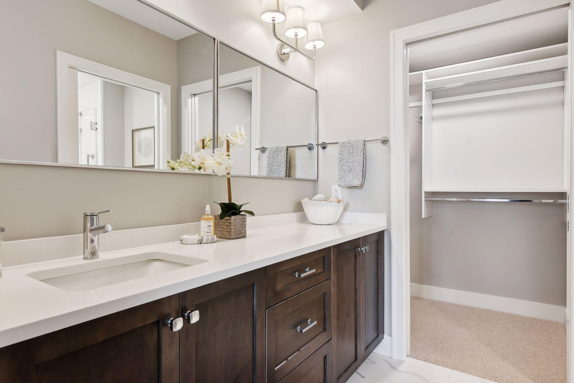 Primary bath with great counter and storage space, heated floors, large walk-in closet