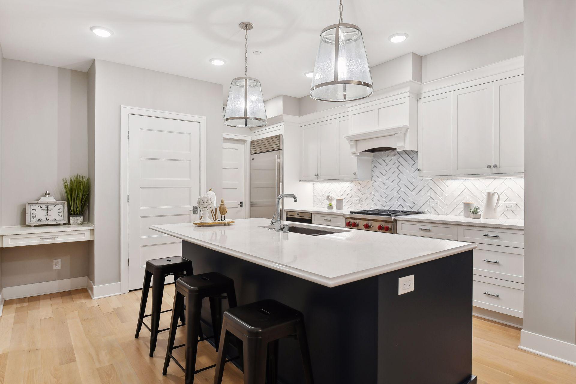 Kitchen features high-end SS appliances, center island, and tiled backsplash. Center island offers a casual breakfast bar for a quick bite to eat