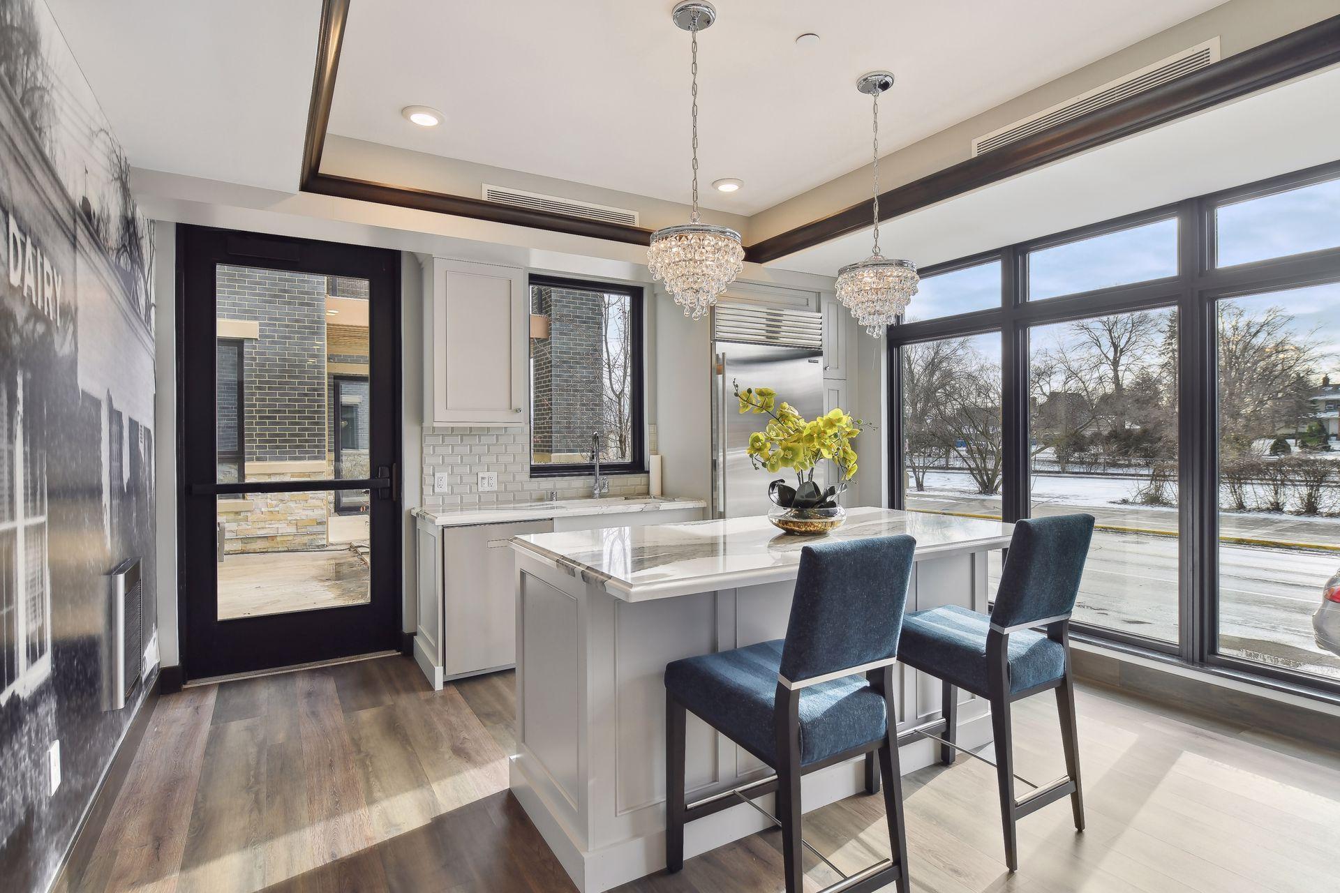 Club room with access to a common patio with fire table and grill