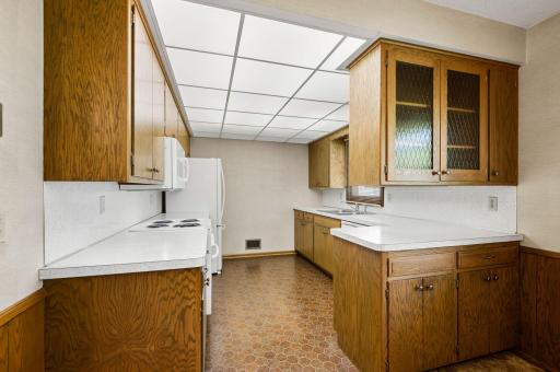 A functional kitchen flows into the dining area