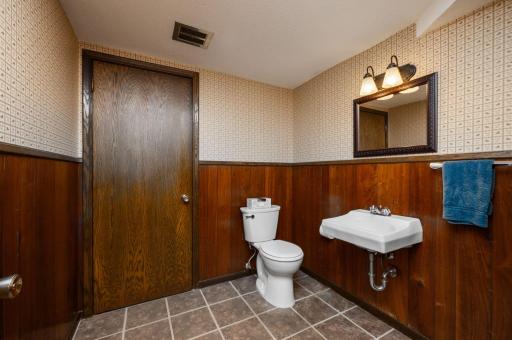 1/2 bath lower level with access to workshop, garage and lower level family room