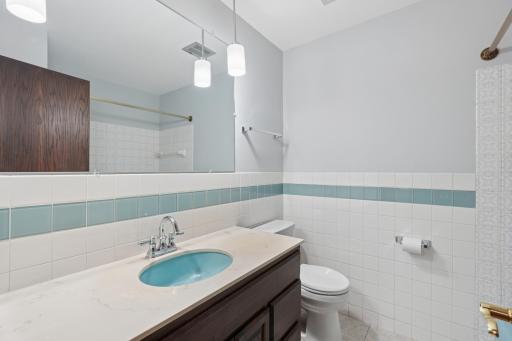 Full bath with updated lighting and new shower head