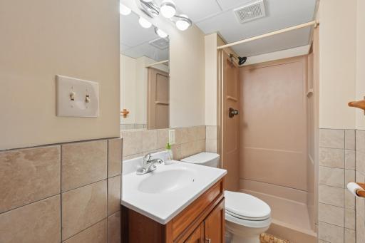 three quarter bath in basement with new lighting and new fixtures