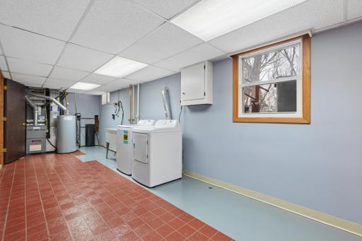 Spacious laundry/utility room with new washer and dryer, newer furnace and water heater