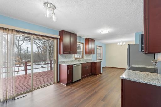 Open layout with eat in kitchen overlooking deck and beautiful large lot